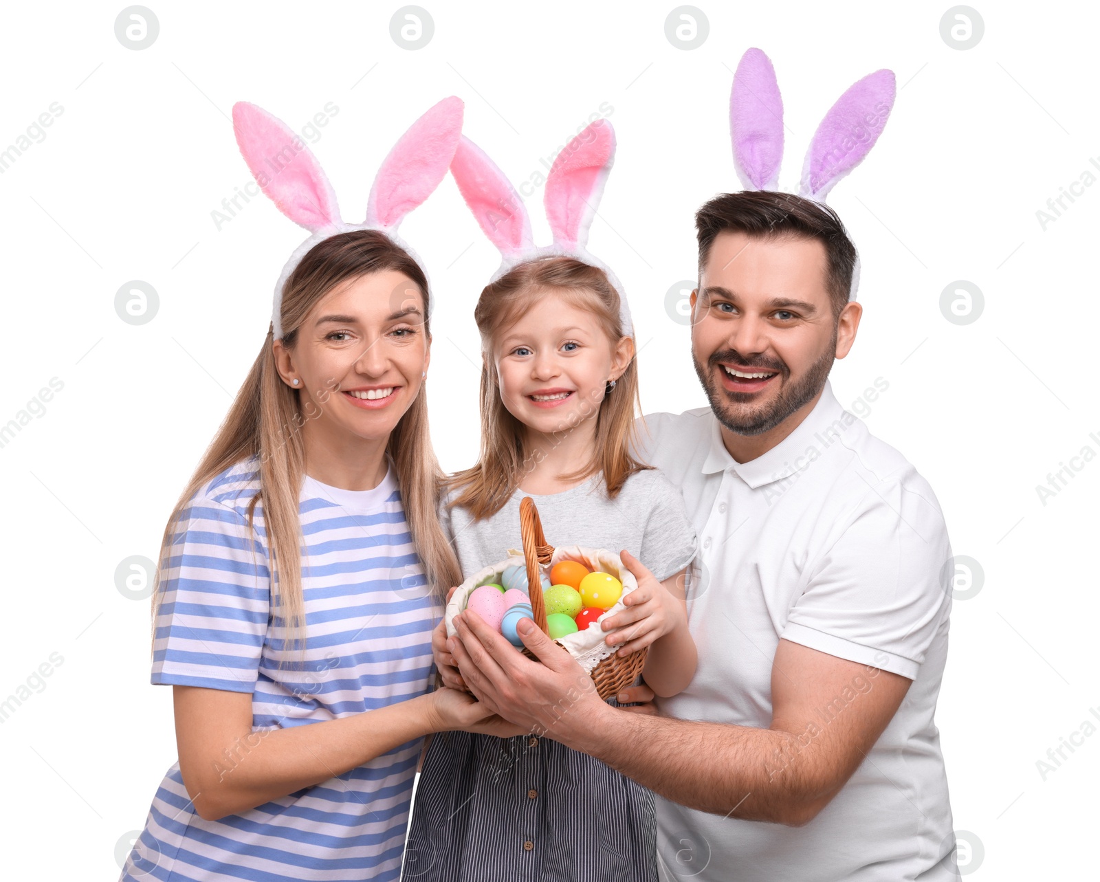 Photo of Easter celebration. Happy family with bunny ears and wicker basket full of painted eggs isolated on white