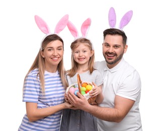 Easter celebration. Happy family with bunny ears and wicker basket full of painted eggs isolated on white