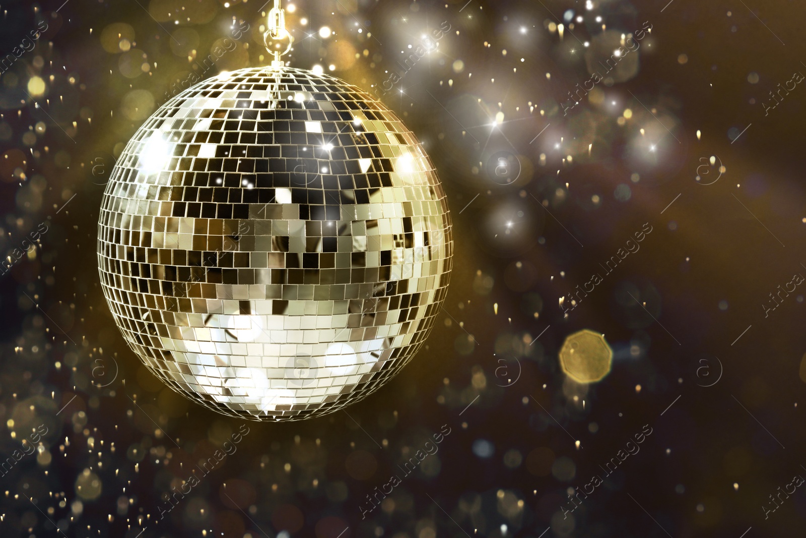 Image of Shiny disco ball under golden lights on dark background, space for text. Bokeh effect