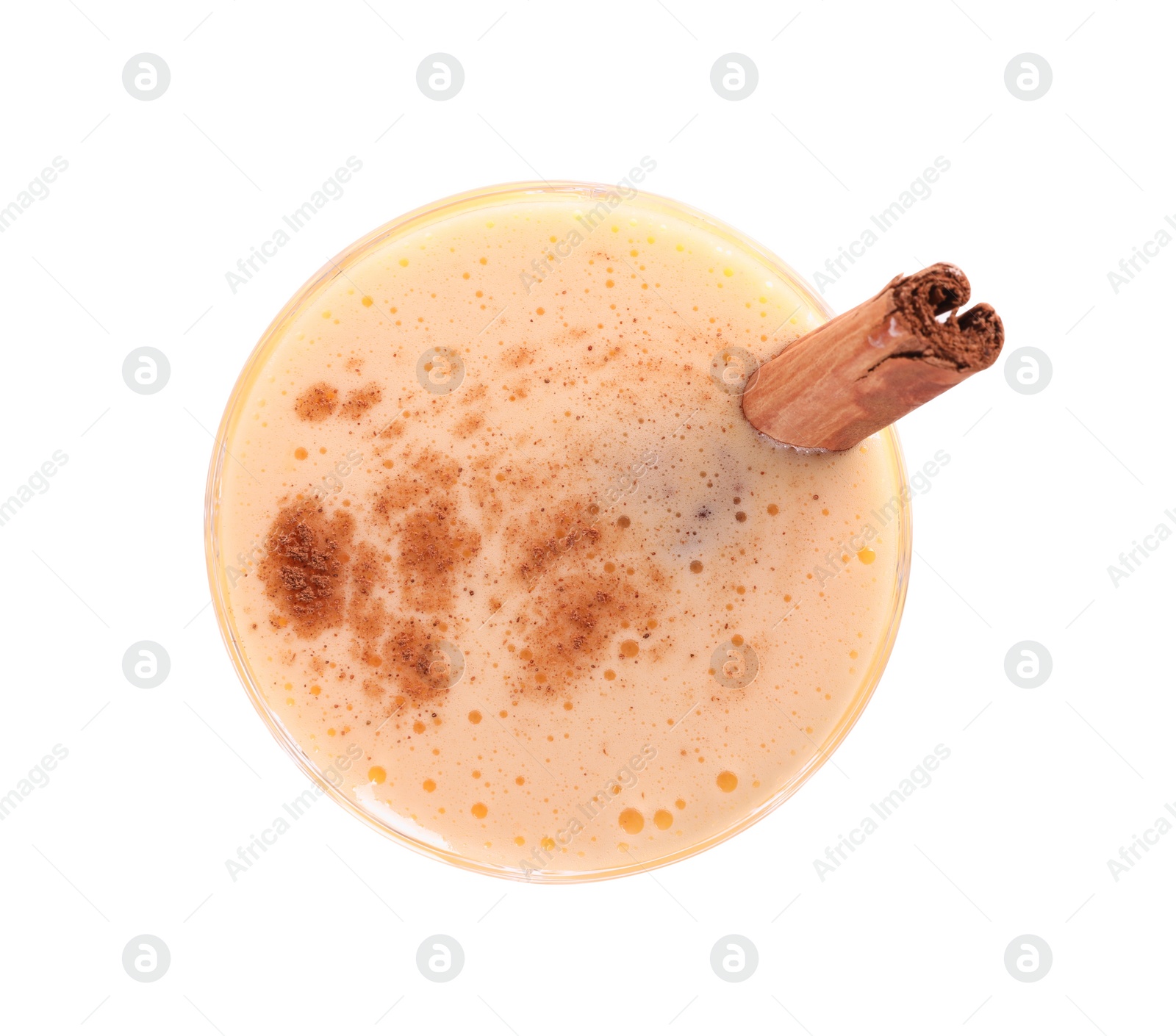 Photo of Glass of delicious eggnog with cinnamon isolated on white, top view