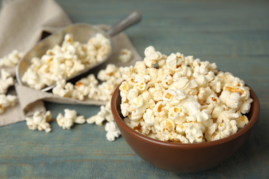 Tasty pop corn on blue wooden table, closeup