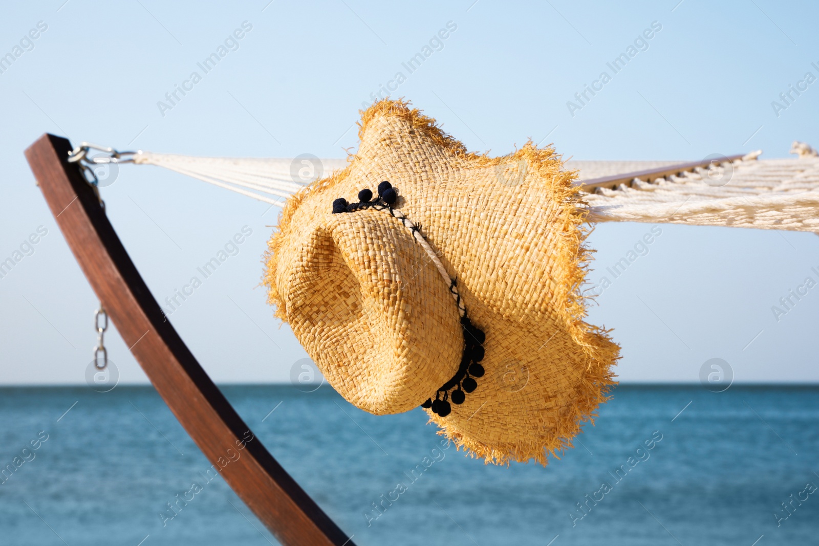 Photo of Hammock and hat at seaside. Time to relax