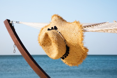 Photo of Hammock and hat at seaside. Time to relax