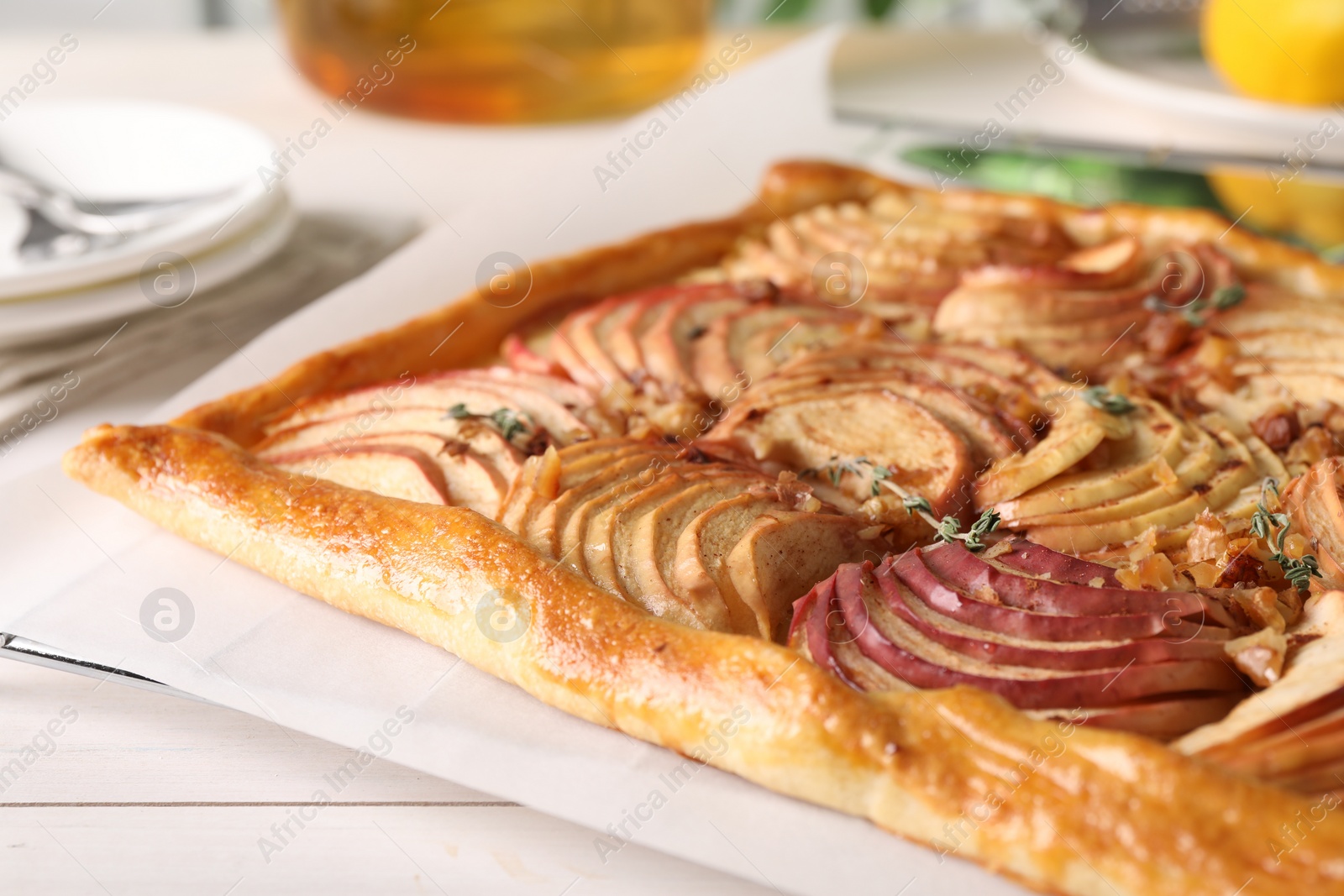 Photo of Freshly baked apple pie on white wooden table, closeup