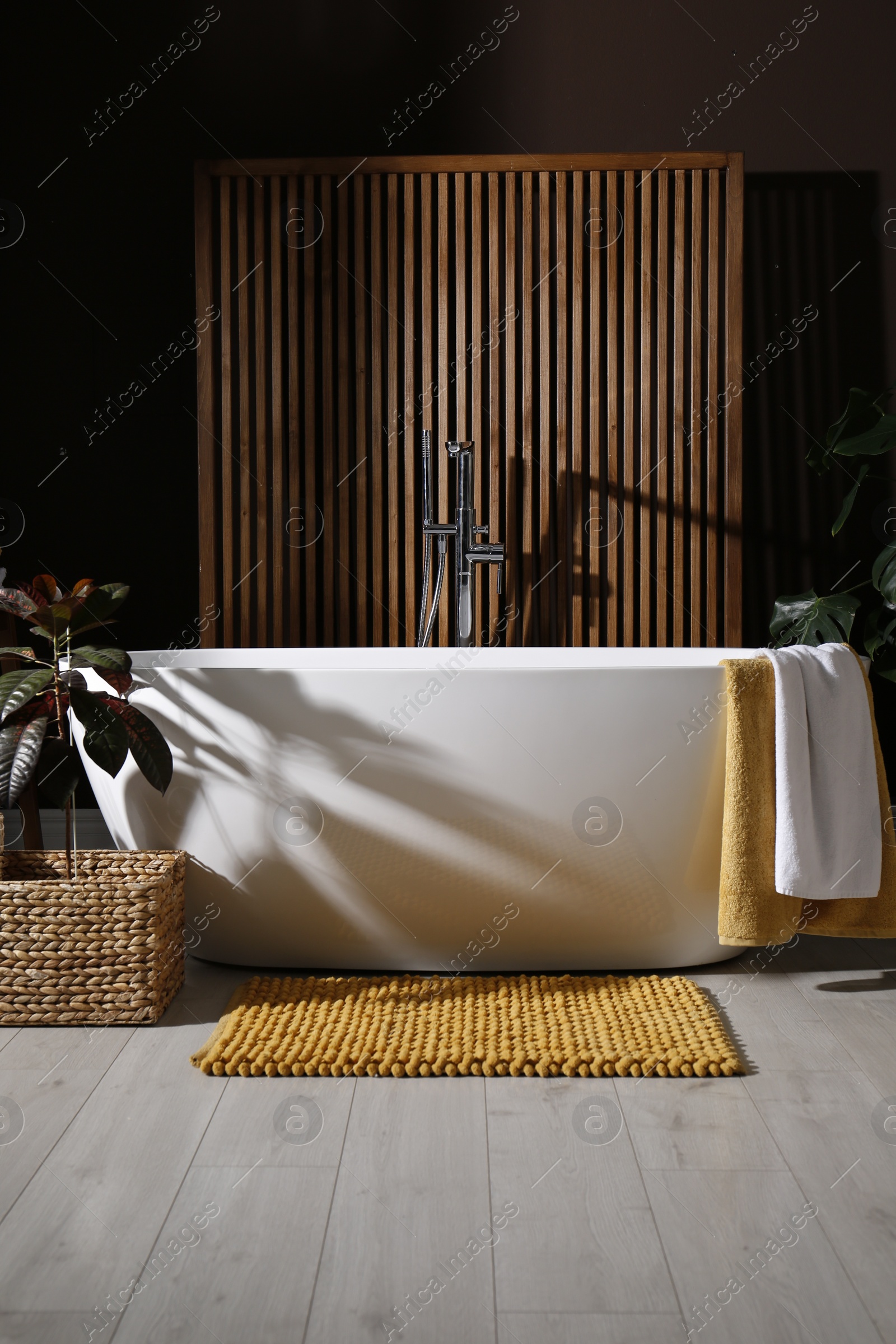 Photo of Cozy bathroom interior with stylish ceramic tub