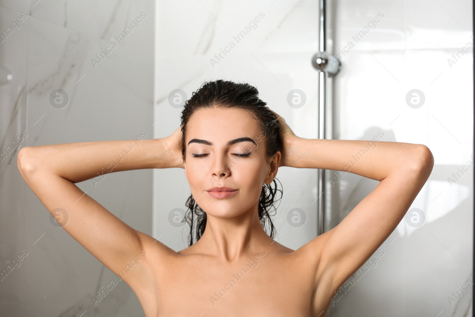 Image of Beautiful young woman taking shower at home