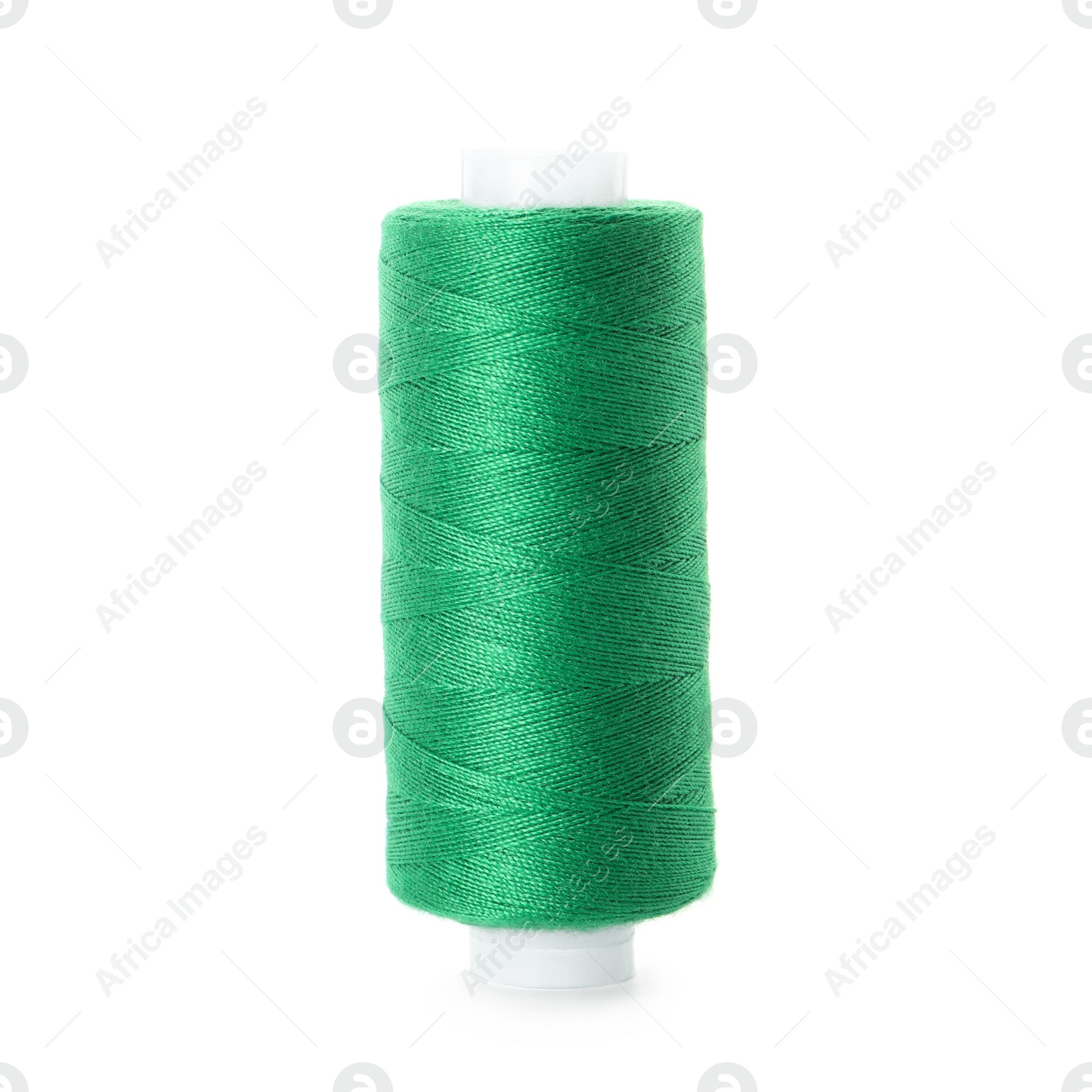 Photo of Spool of green sewing thread isolated on white