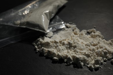 Photo of Drug addiction. Cocaine on dark textured table, closeup