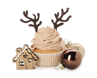 Photo of Delicious cupcake with chocolate reindeer antlers and Christmas decor on white background