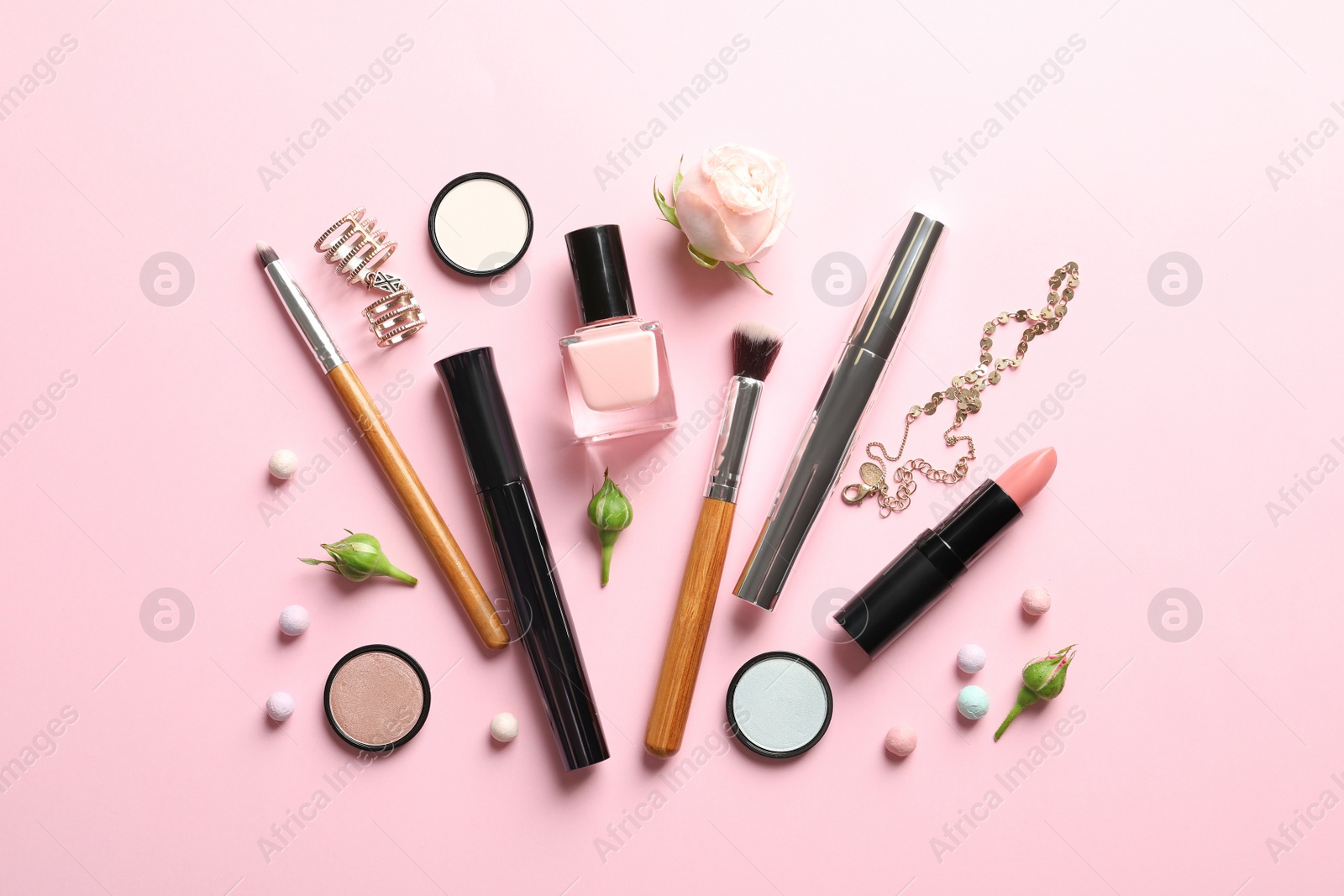 Photo of Flat lay composition with products for decorative makeup on pastel pink background