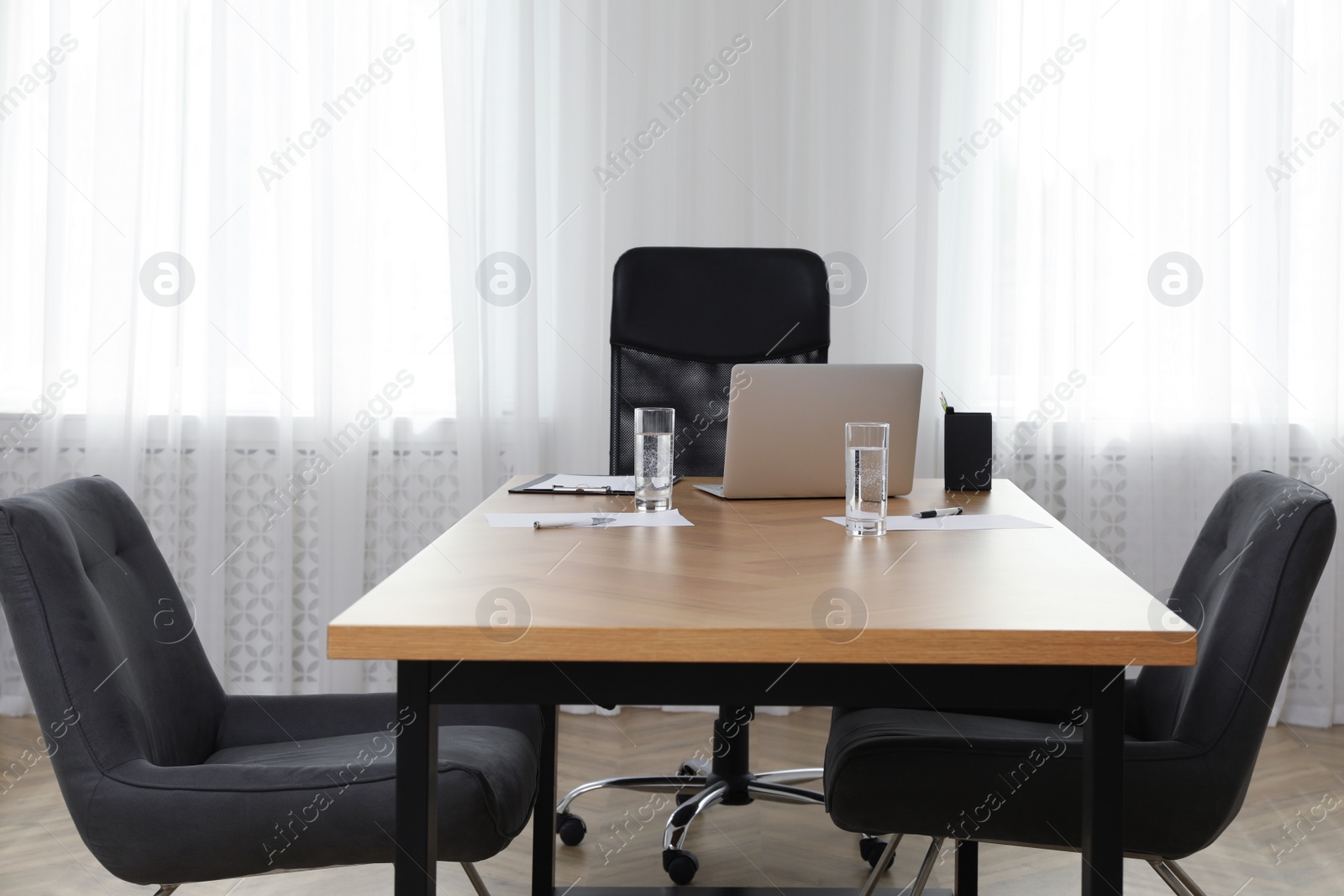 Photo of Director's office with large wooden table and comfortable armchairs. Interior design