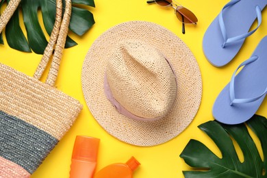 Photo of Flat lay composition with straw hat on yellow background