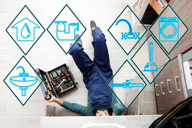 Image of Sanitary engineering service. Professional plumber repairing kitchen sink, top view