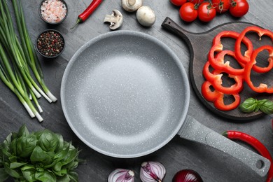 Flat lay composition with frying pan and fresh products on grey table