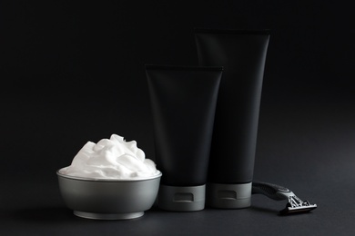 Photo of Set of shaving equipment and men's cosmetic products on black background