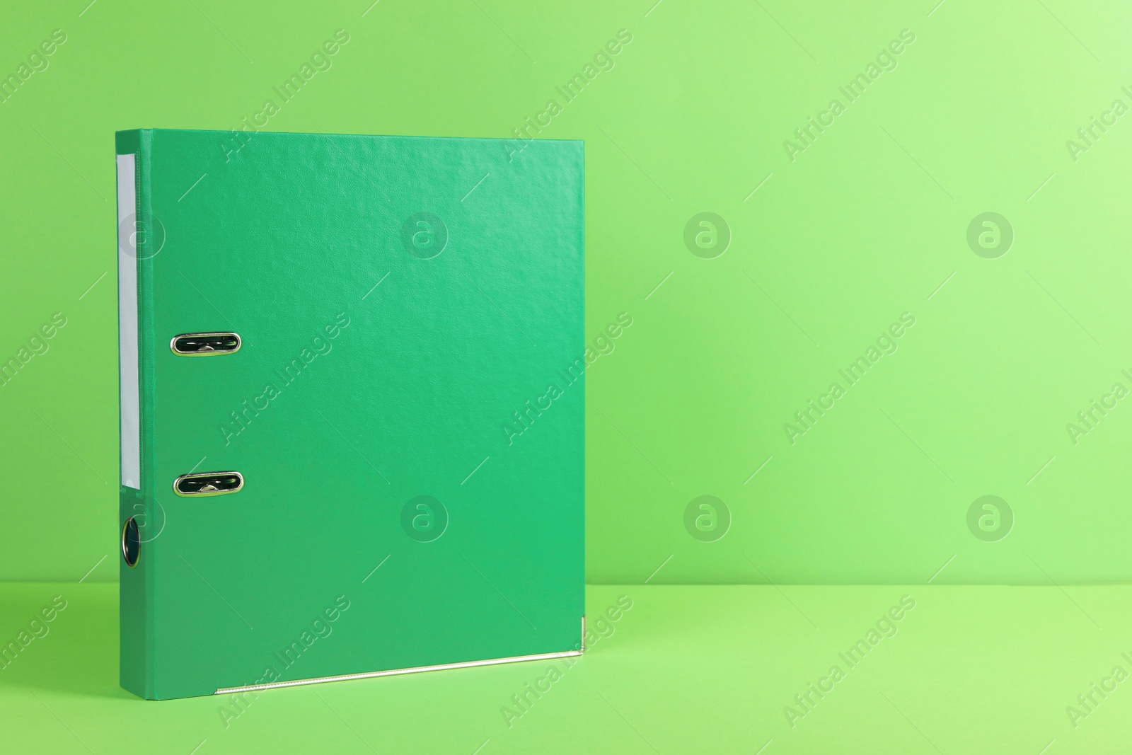 Photo of Office folder on light green background, space for text