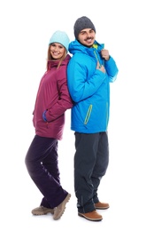 Young couple wearing warm clothes on white background. Ready for winter vacation