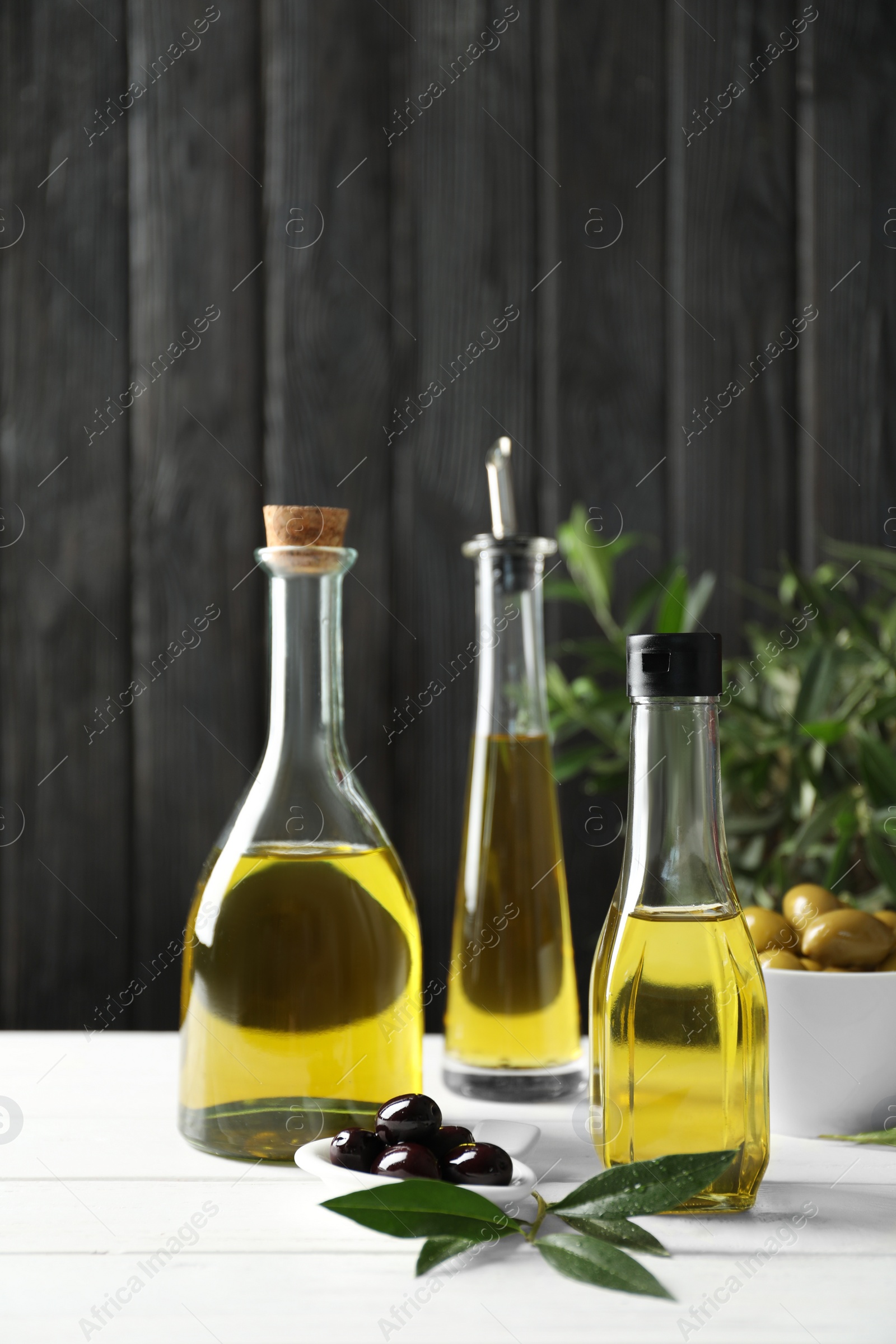 Photo of Composition with fresh olive oil on table