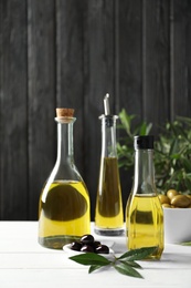 Composition with fresh olive oil on table