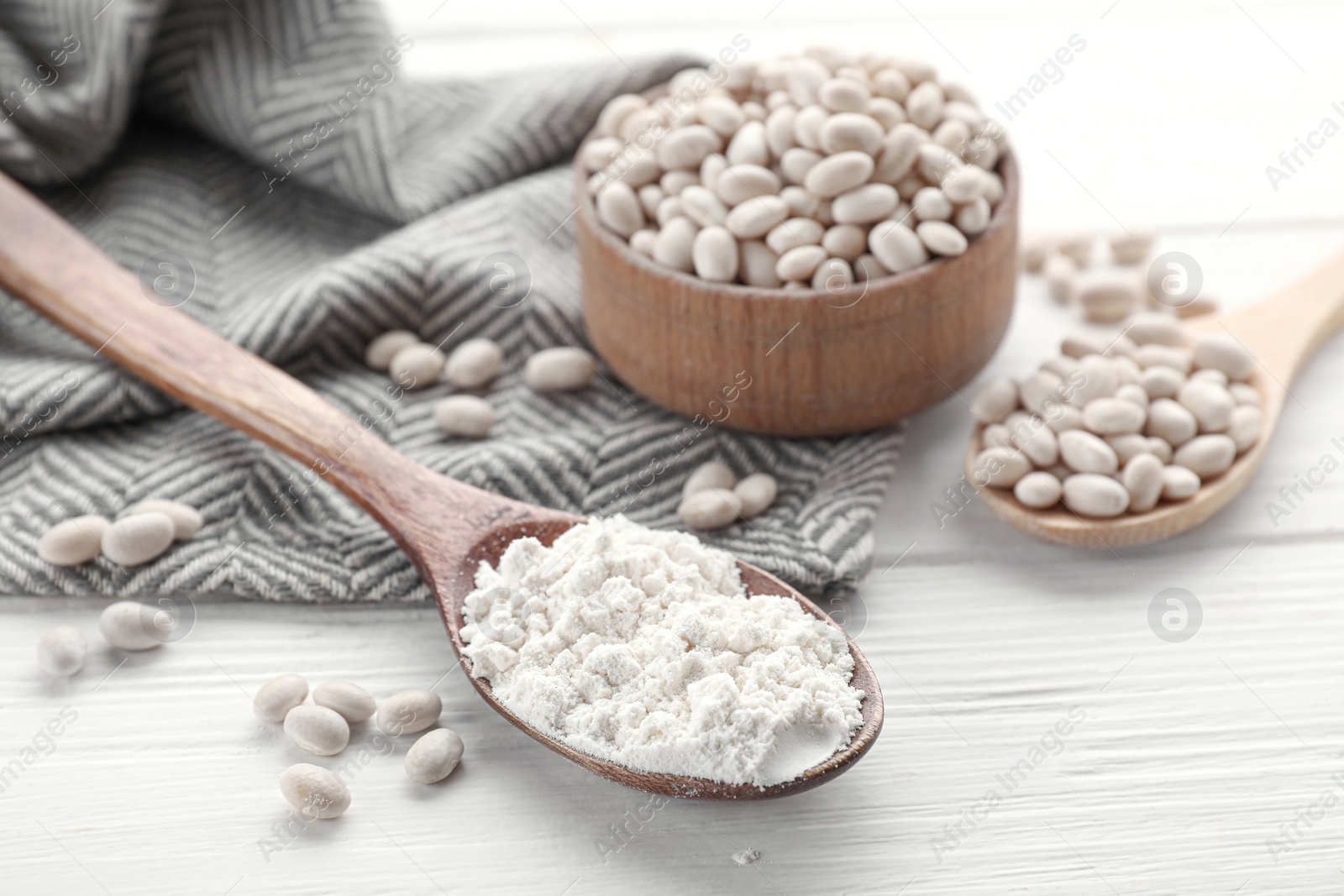 Photo of Kidney bean flour and seeds on white wooden table