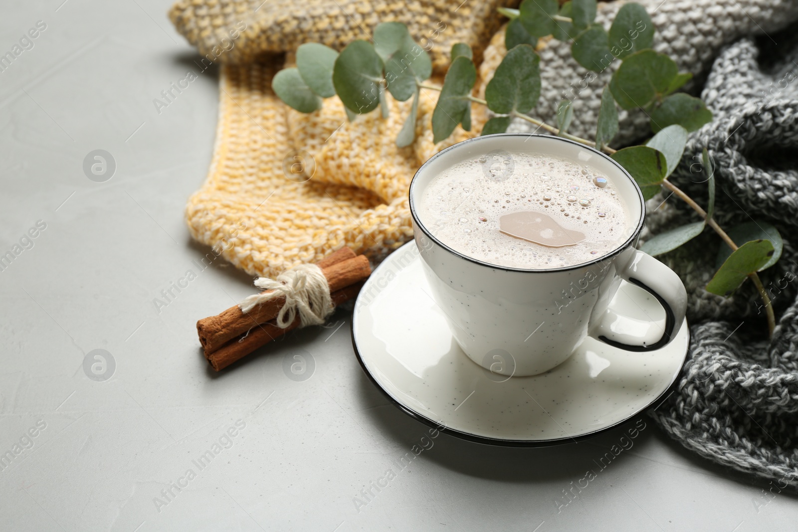 Photo of Composition with coffee and warm plaid on light table