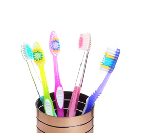 Photo of Cup with different toothbrushes on white background. Dental care