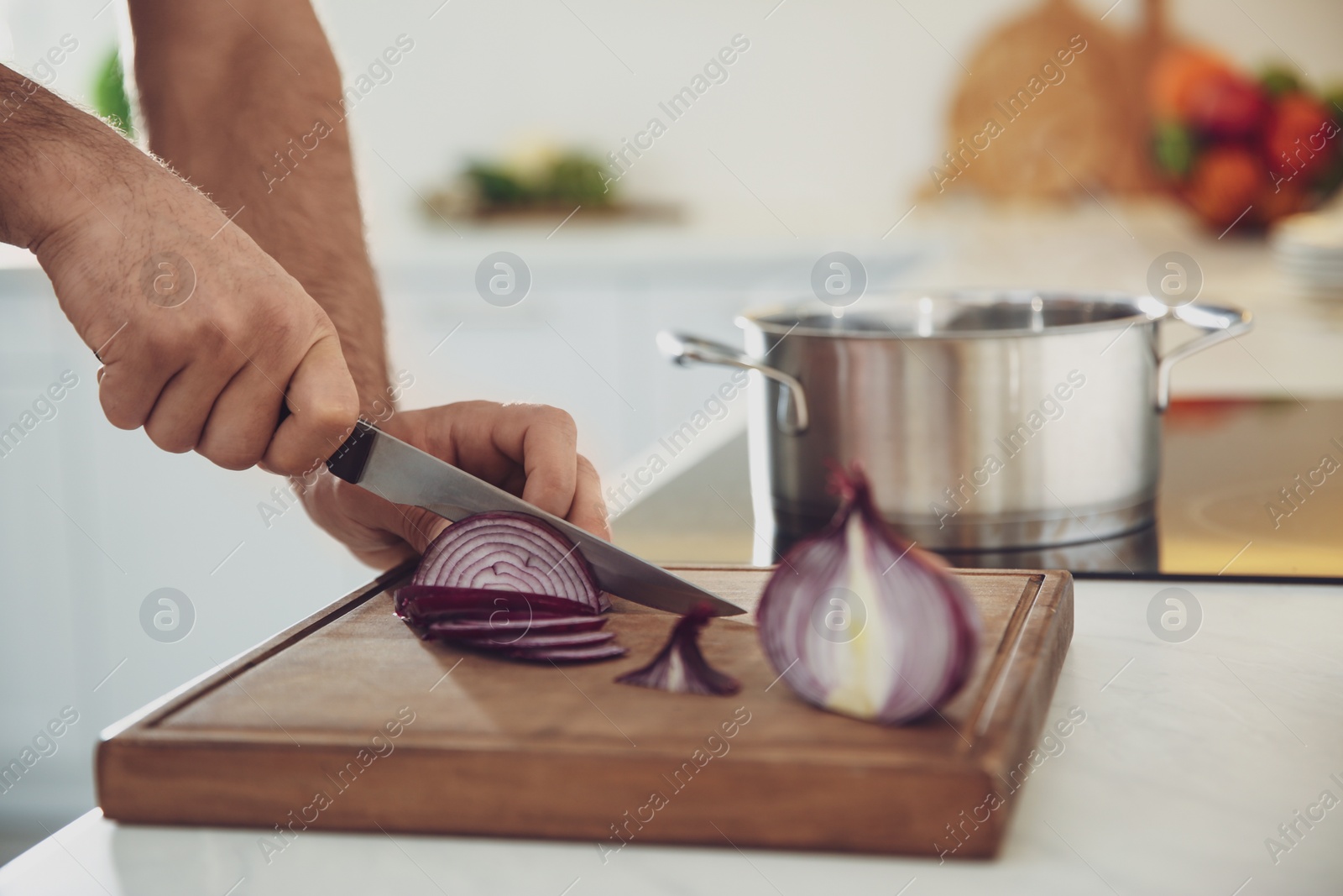 Photo of Man cooking at counter in kitchen, closeup