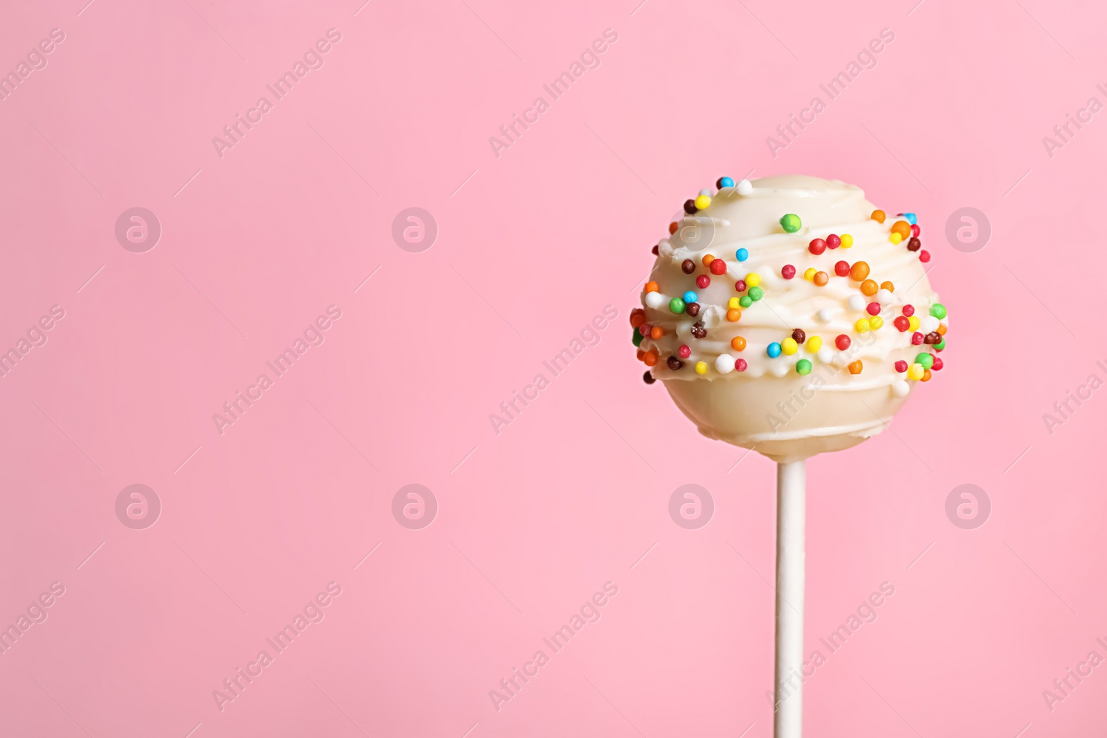 Photo of Bright delicious cake pop on color background. Space for text