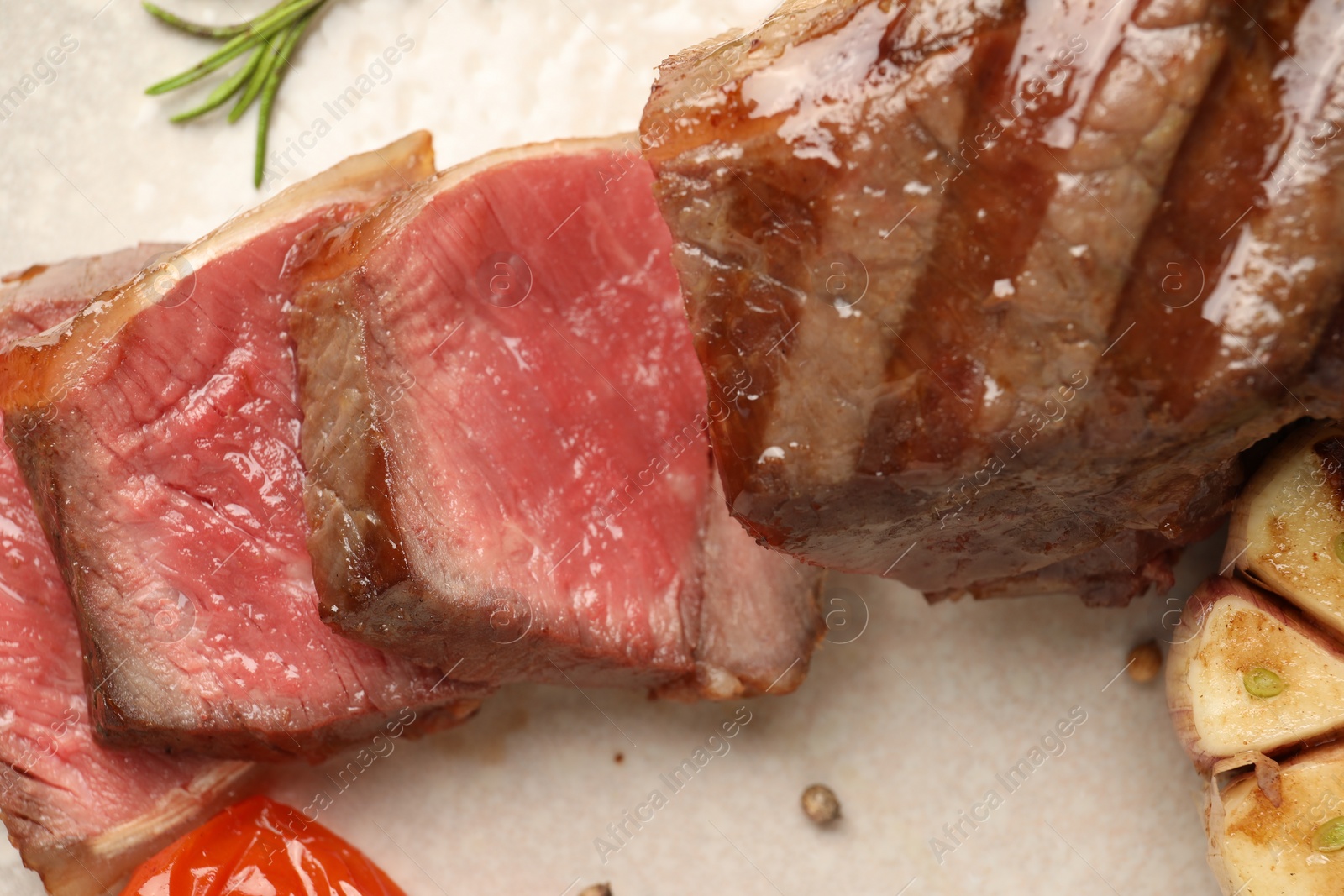 Photo of Delicious grilled beef steak with spices on plate, top view