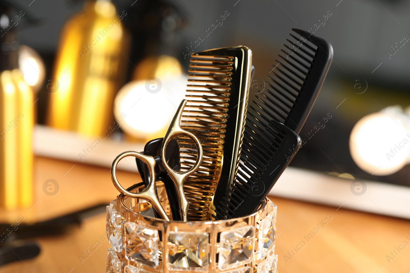 Photo of Set of hairdresser tools on table in salon, closeup