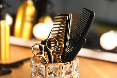 Set of hairdresser tools on table in salon, closeup