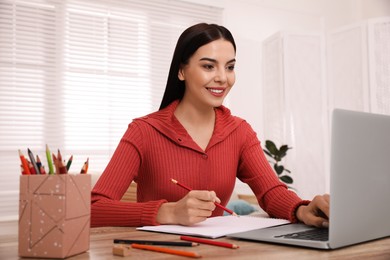 Photo of Happy woman drawing picture at online art lesson indoors. Distant learning