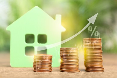 Mortgage rate. Model of house, stacked coins, graph, percent sign and arrow