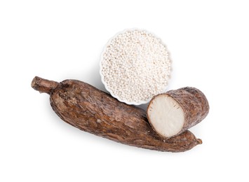 Tapioca pearls in bowl and cassava roots isolated on white, top view