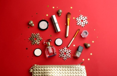 Flat lay composition with decorative cosmetic products on red background. Winter care