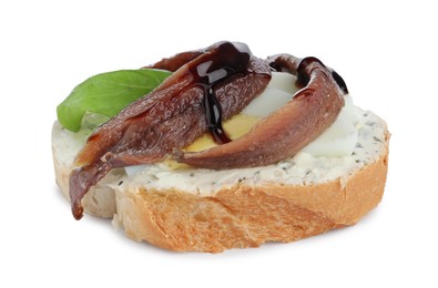 Delicious bruschetta with anchovies, eggs, basil and sauce on white background