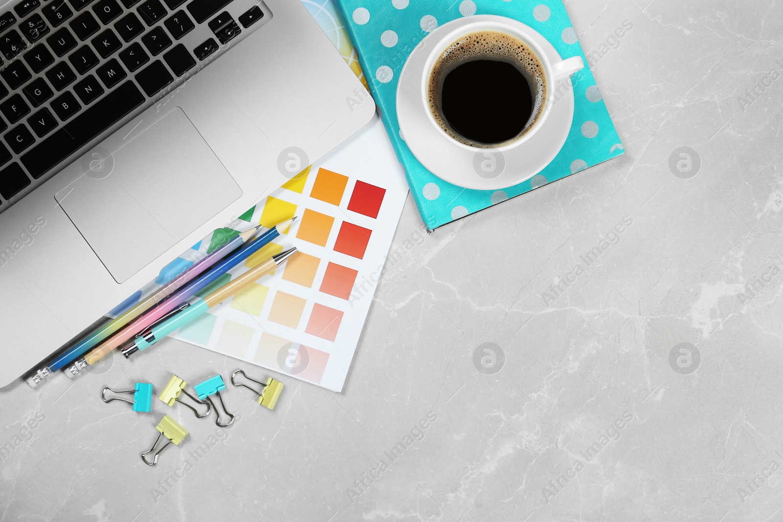 Photo of Flat lay composition with laptop on marble table, space for text. Designer workplace