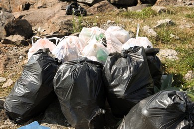 Photo of Many trash bags full of garbage outdoors. Environmental Pollution concept