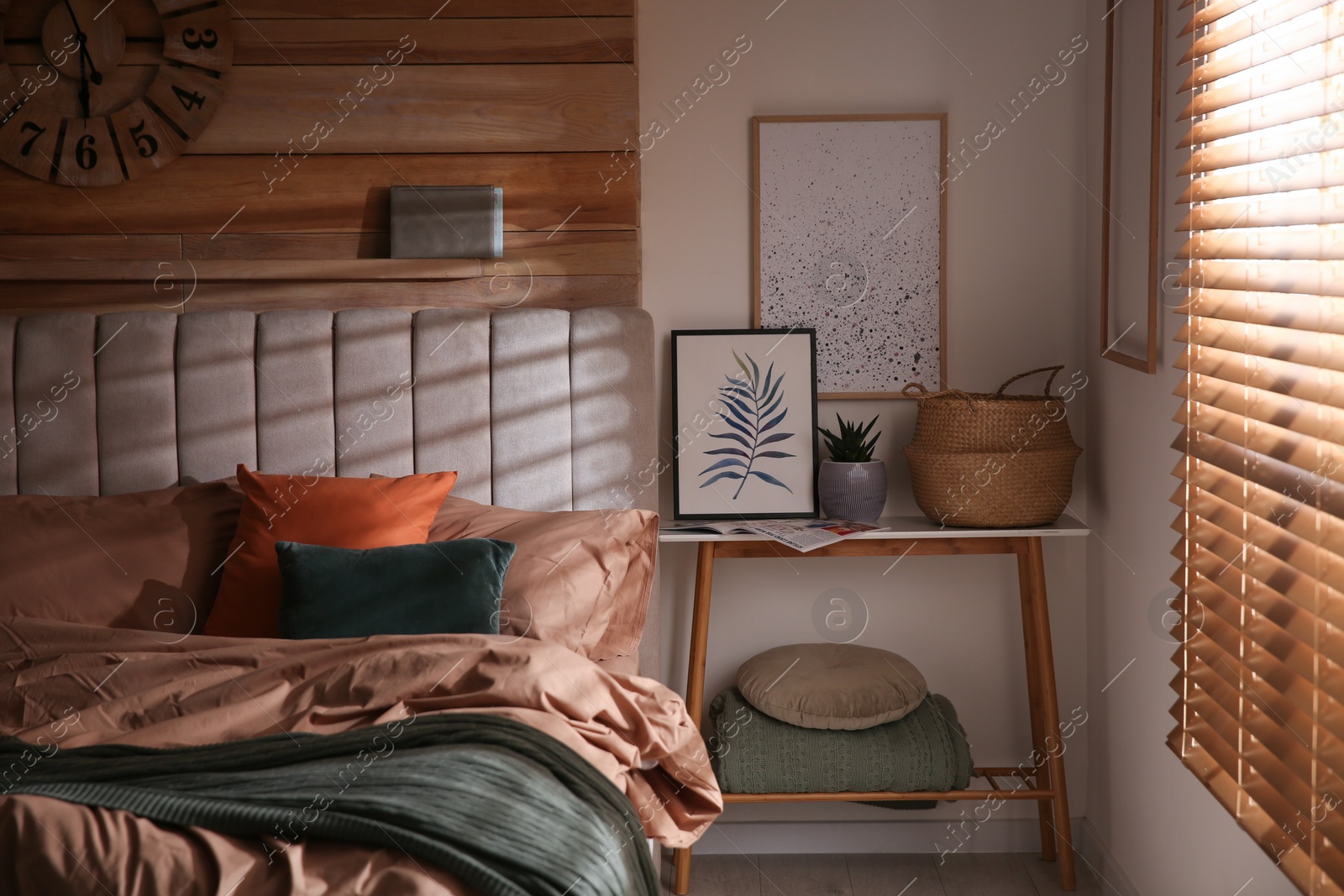 Photo of Bed with stylish linen and soft pillows in room