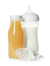 Photo of Bottles with juice, milk and nibbler isolated on white. Baby nutrition