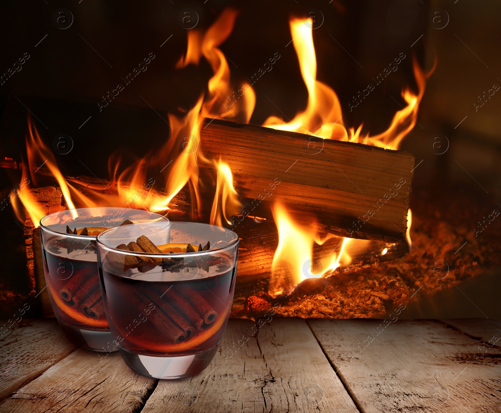 Image of Mulled wine on wooden table near fireplace