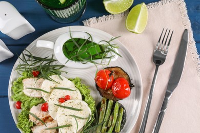 Photo of Tasty mozzarella, chicken and vegetables with tarragon served on table, flat lay