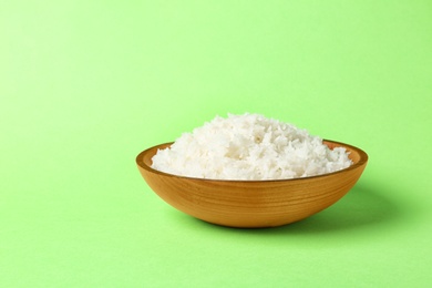 Photo of Bowl of boiled rice on color background. Space for text