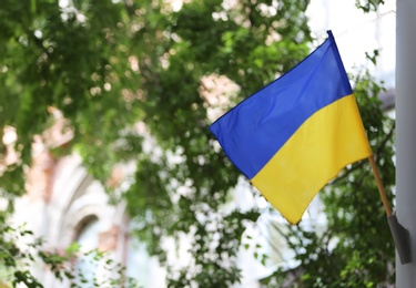 Photo of National flag of Ukraine attached to pole outdoors