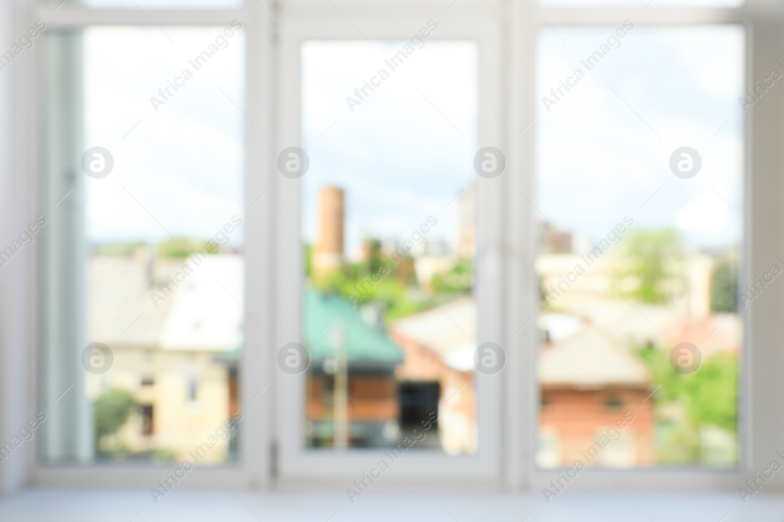 Photo of Blurred view of big window with white plastic frame