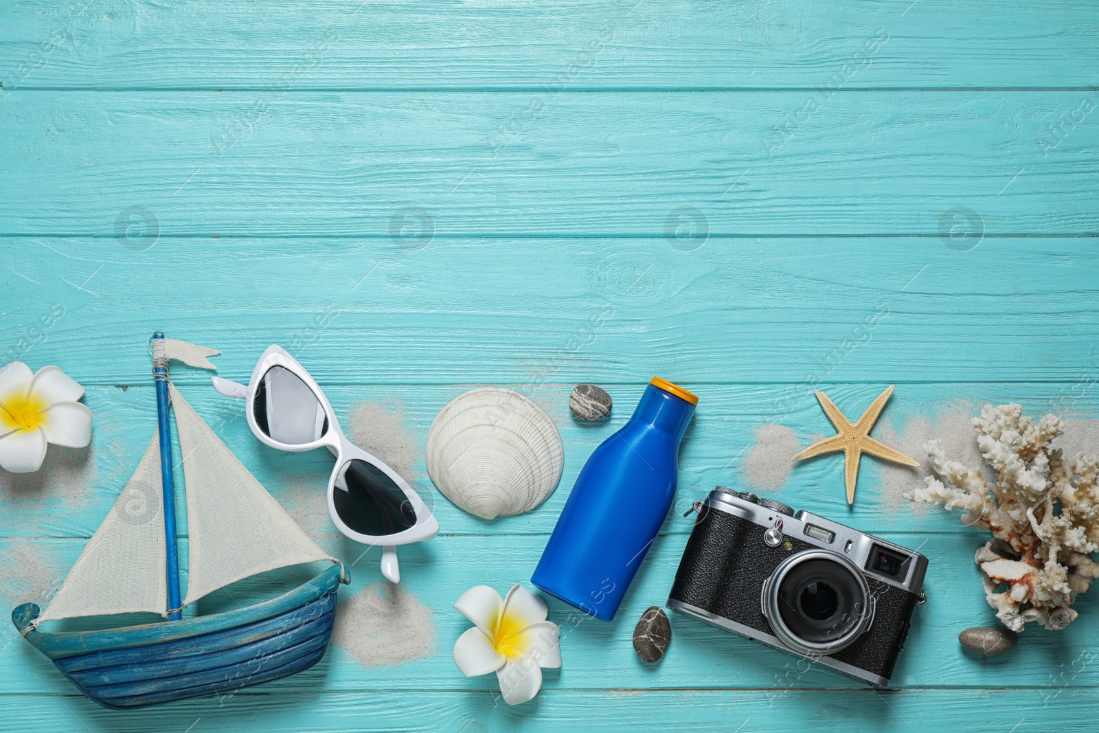 Photo of Flat lay composition with stylish beach accessories on light blue wooden background, space for text