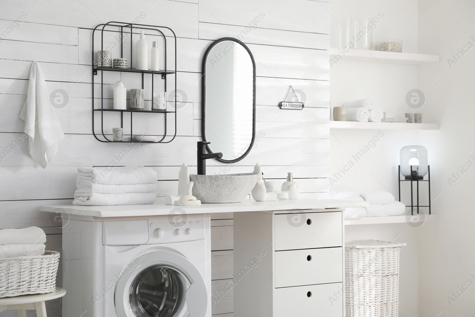 Photo of Stylish bathroom interior with modern washing machine