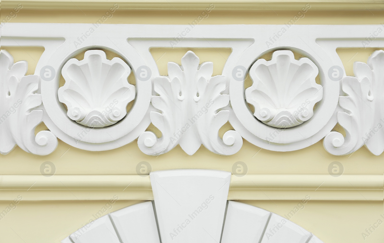 Photo of Beautiful beige wall with ornate white moldings