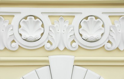 Photo of Beautiful beige wall with ornate white moldings