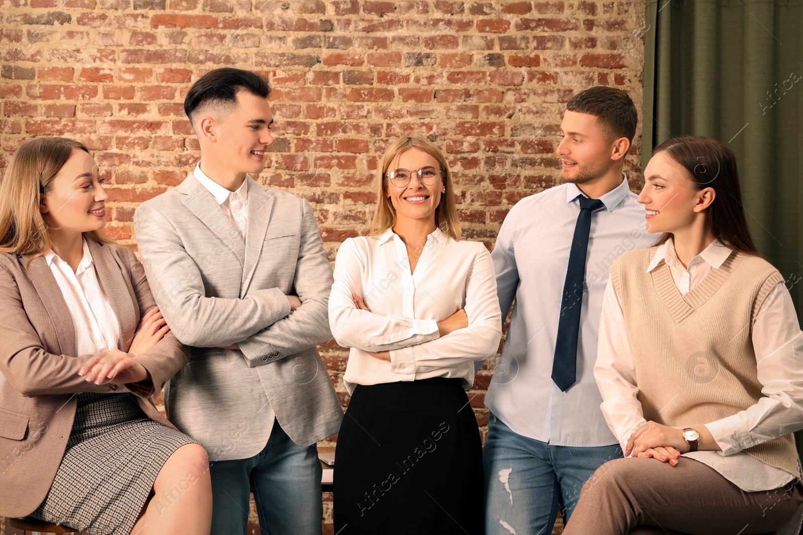 Photo of Businesswoman and her employees in office. Lady boss